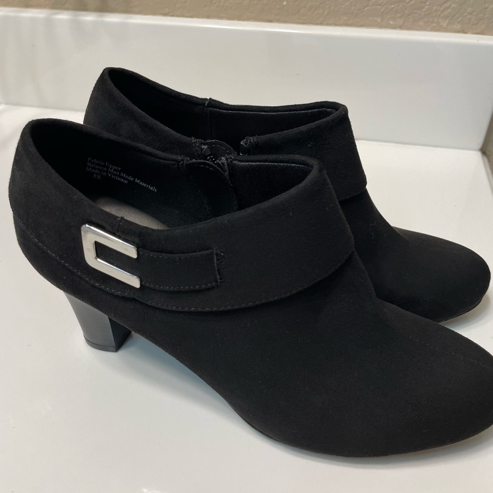 Aubrey Lynn black suede booties with metal accent.